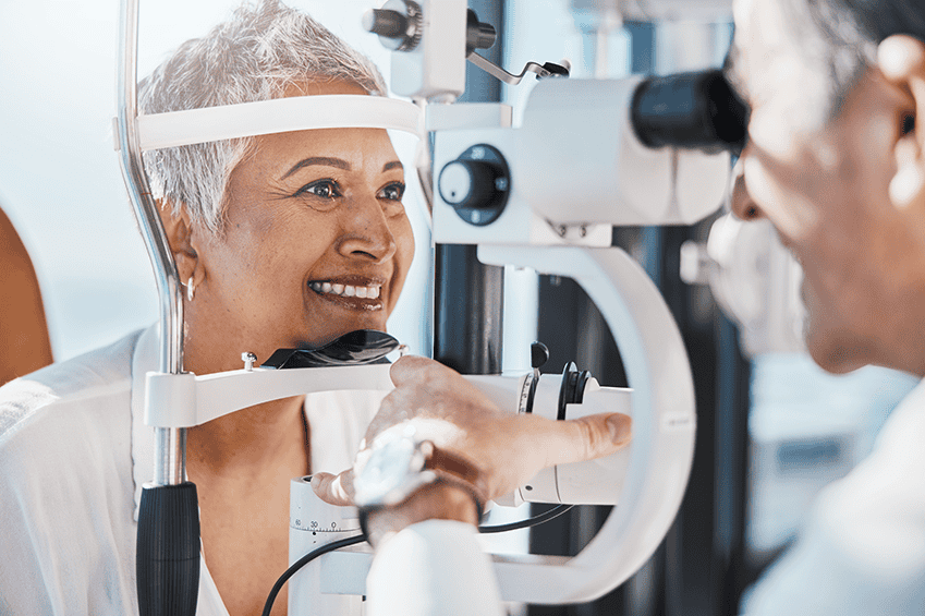 Case-Study-Revolutionizing-Referral-Management-Referral-Portal | A woman with short white hair wearing a white shirt is shown having an eye exam